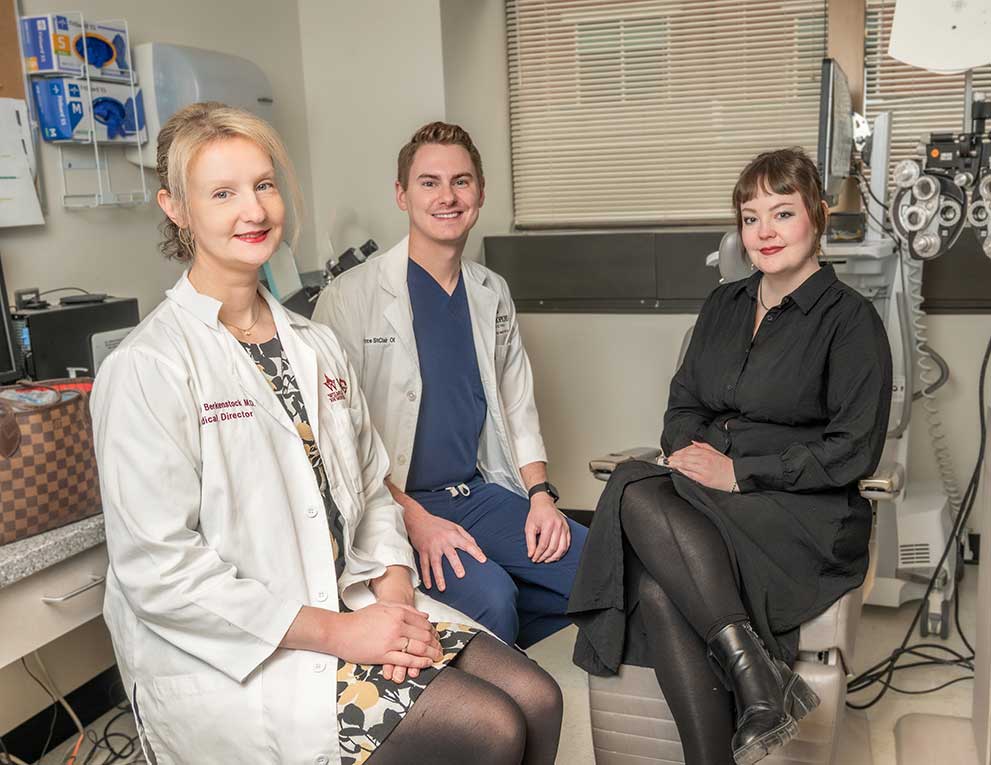 Meghan Berkenstock and Bryce St Clair in white coats sitting beside Kylie Myles