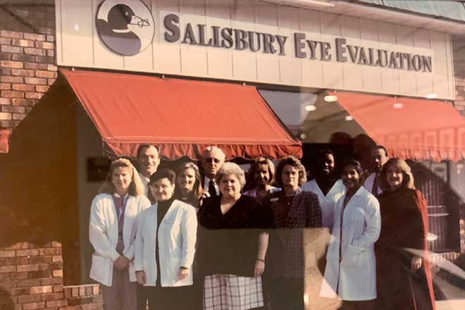 Team photo in front of the Salisbury Eye Evaluation sign
