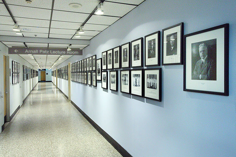 Long hallway with wall of portraits