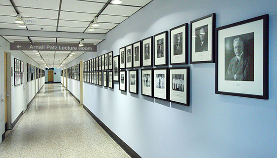 Long hallway with wall of portraits