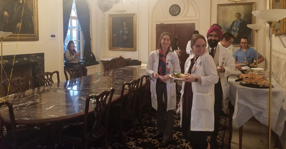 Wilmer residents and staff eating lunch in Portrait Room