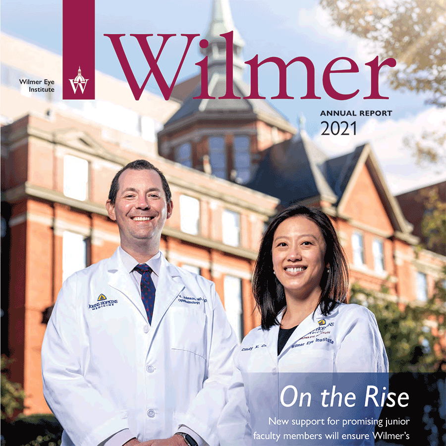 Annual report 2021 cover showing two physicians in white coats standing in front of the Hopkins dome building. The headline reads one the rise.