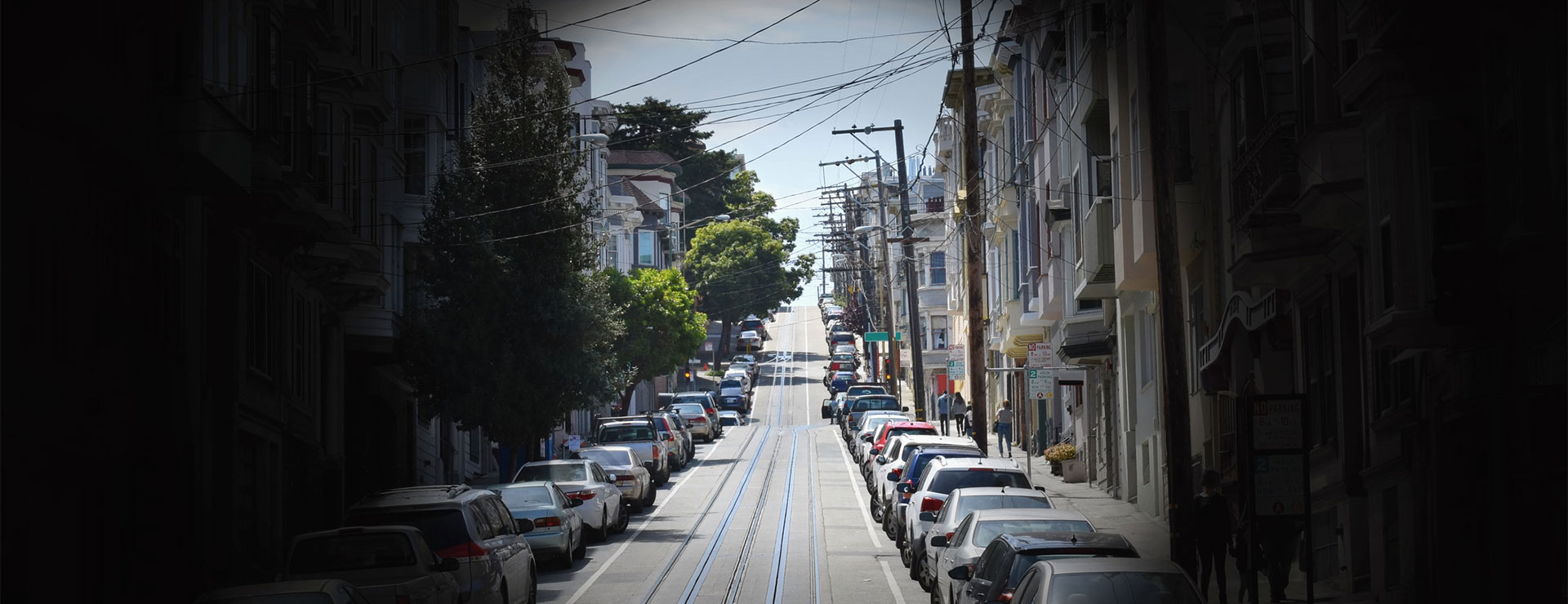 A rendering of what it's like to experience Retinitis Pigmentosa, showing a street viewed through a pinhole.
