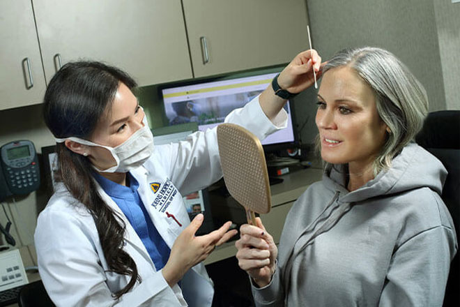 Dr. Li works examines a patient at the Wilmer Eye Institute