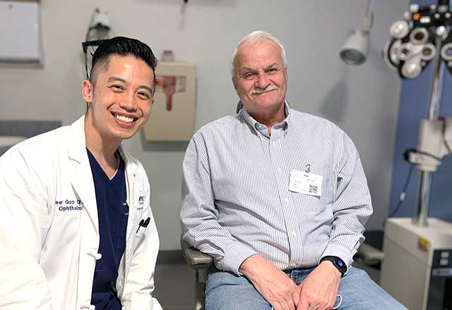 Dr. Guo smiling with a patient in an exam room