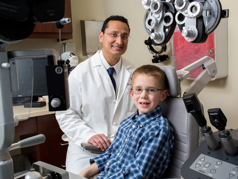 Wilmer doctor Akrit Sodhi with a young patient