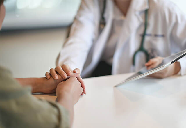 doctor-holds-womans-hand