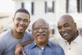 Three generations of African-American men smiling at the camera