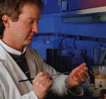 Picture of a male pathologist, labeling a specimen