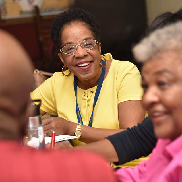 Adrian Mosley talking to people at a table