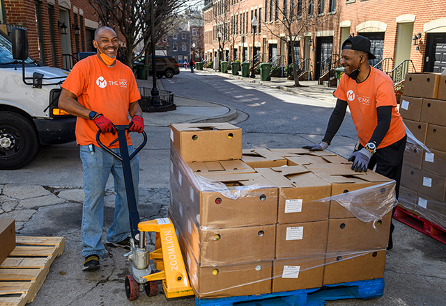 Members of the Mix Church transport supplies for distribution at community organizations.