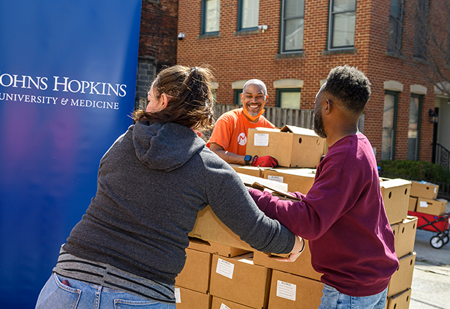 Members of the Mix Church form an assembly line to load supply boxes.