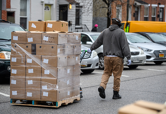 A volunteer from The Door transports supplies for distribution at community organizations.