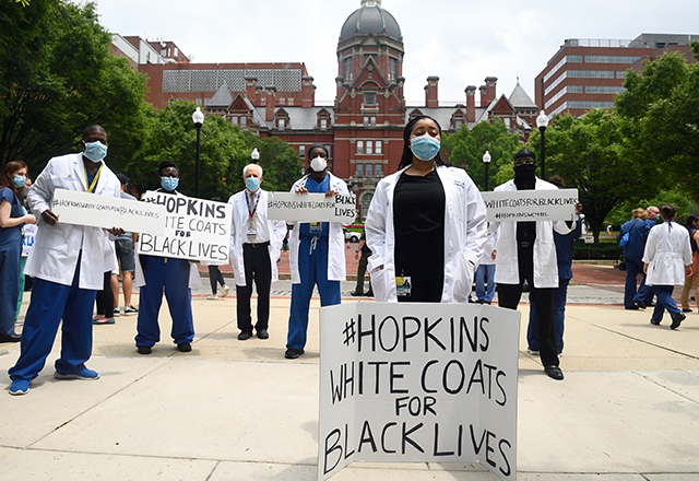 Rothman stands among other white coats during the White Coats for black lives event.