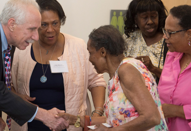 Rothman shaking hands with an African American