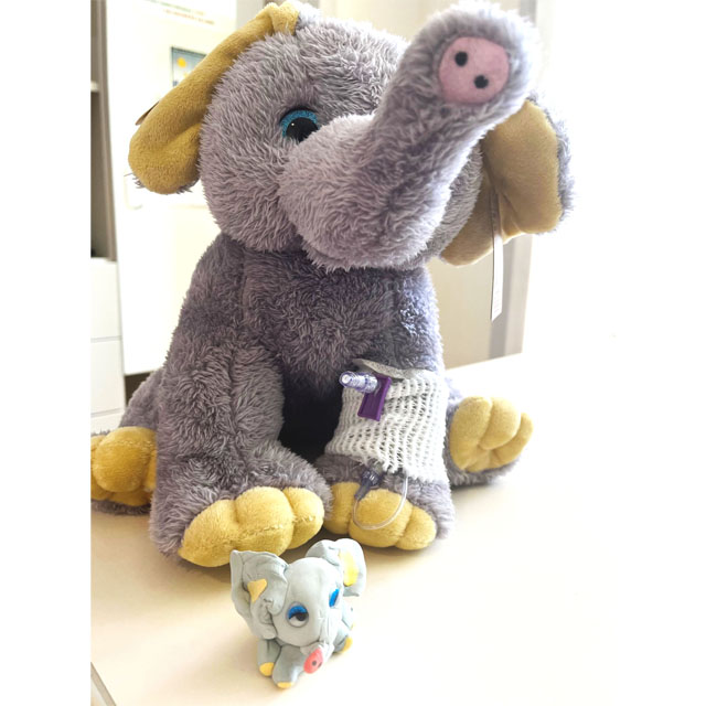 stuffed elephant “Leon,” with another made from clay