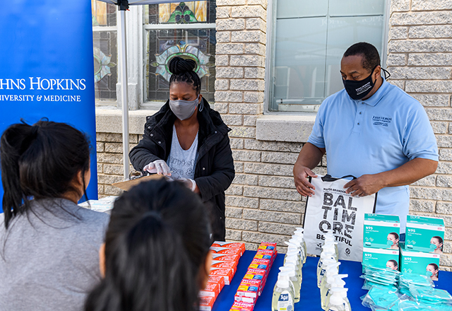 Johns Hopkins Government and Community Affairs staff and volunteers from The Door, an East Baltimore nonprofit organization, distribute COVID-19 supplies to the community.