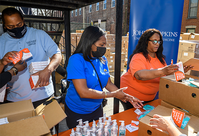 Members of the Mix Church and Johns Hopkins Government and Community Affairs staff distribute the supplies.