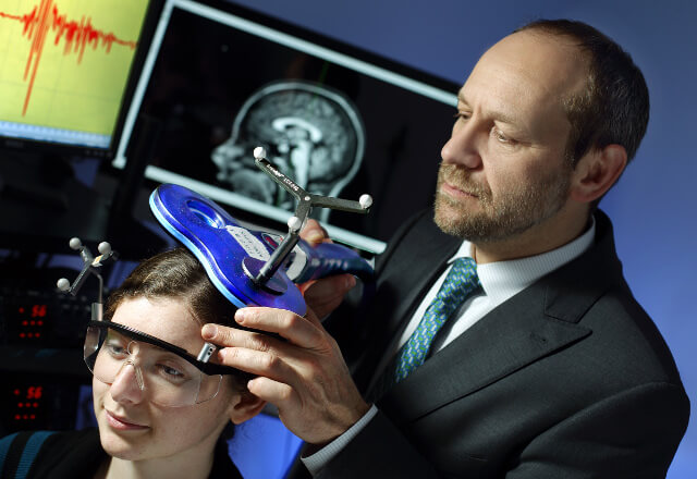 Doctor places a NIBS device on a patient's head