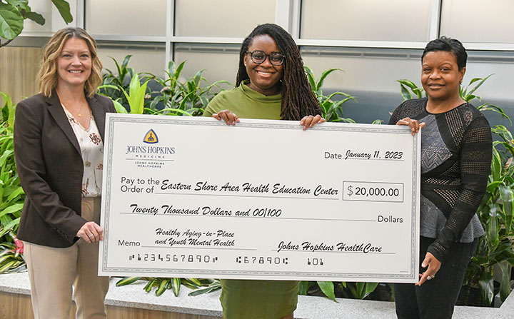 Executive Director of ESAHEC, Ashley Clark (center) accepts a $20,000 grant check 