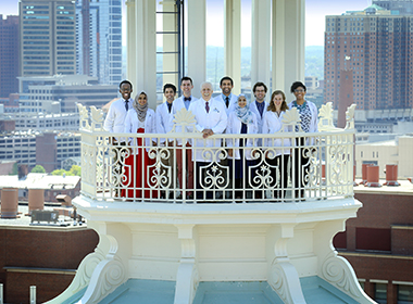 A photo of Dean/CEO Paul Rothman celebrating the 125th anniversary of the Johns Hopkins University School of Medicine in 2018 with medical students.
