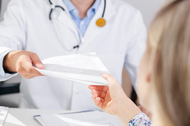 doctor handing patient papers