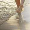 Close up of feet of Caucasian patient walking along beach