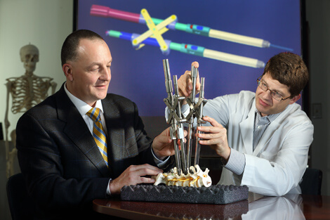 Engineer Dan Stoianovici, left, and neurosurgeon Jean-Paul Wolinsky are working on better devices for neurosurgery.