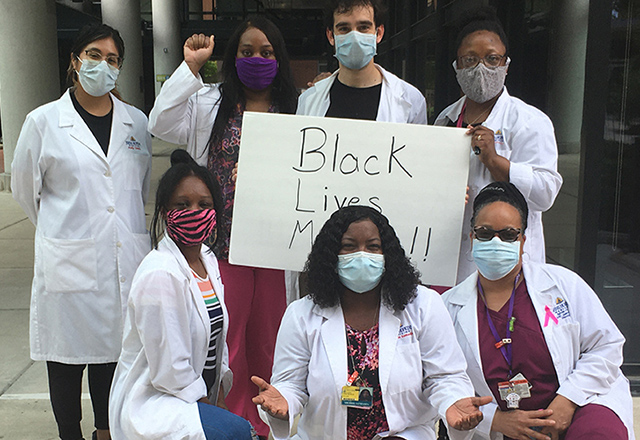 Hopkins affiliates wearing masks and standing in solidarity for Black lives.