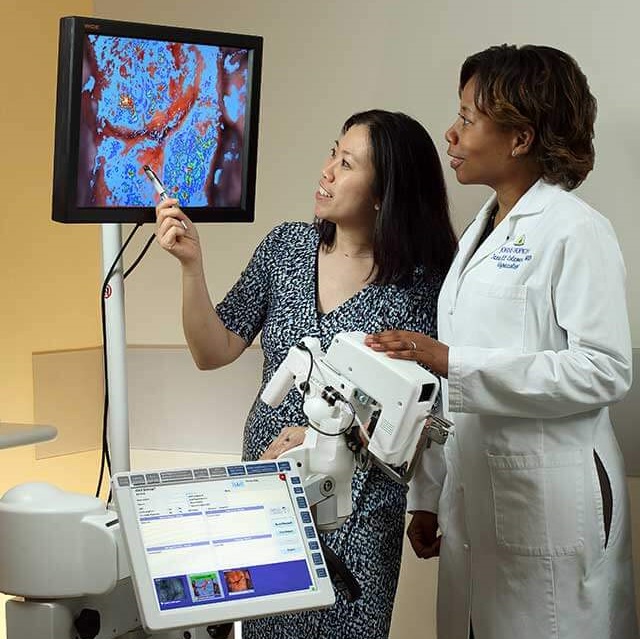 Doctors Chou and Coleman assess imaging on screen of colposcopy device
