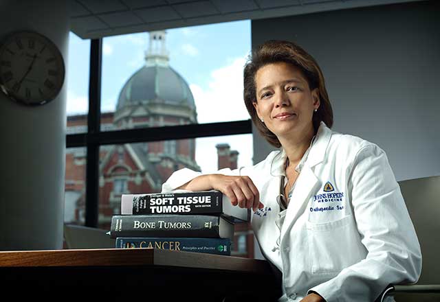 image of Dr. Morris leaning on books.