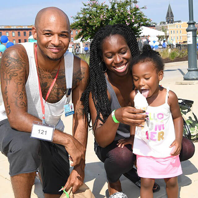 A photo shows Terrence Woods, Chimere Walden and their daughter, Camryn Woods.
