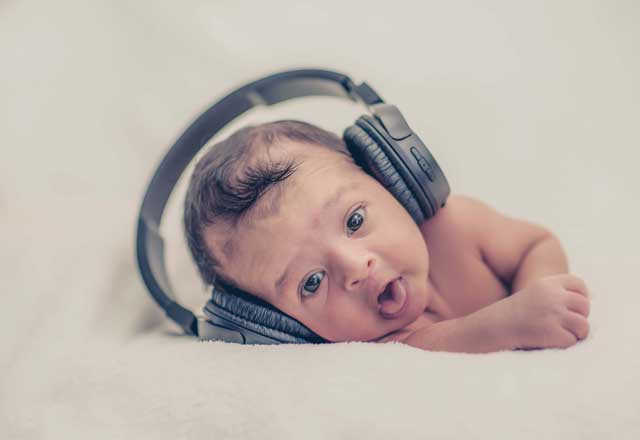 Newborn baby with headphones