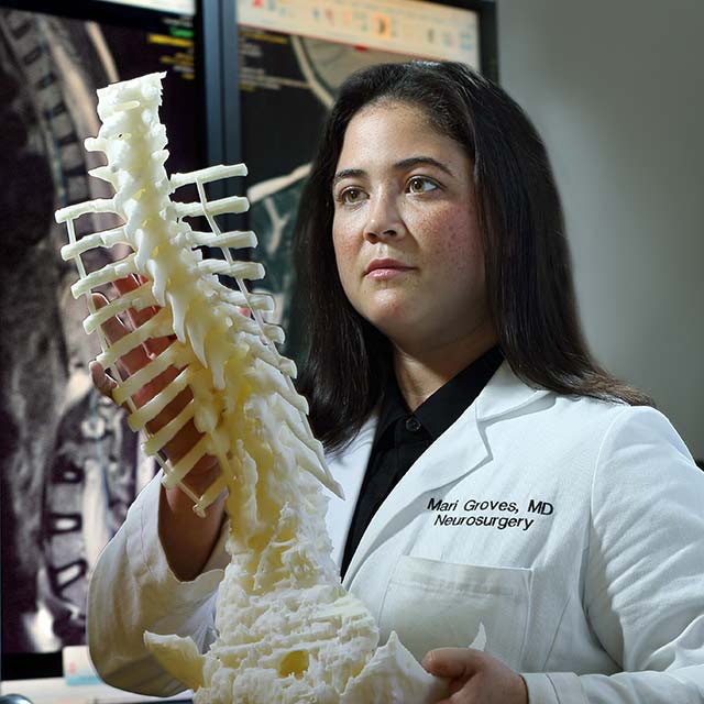 Dr. Groves examines a model spine