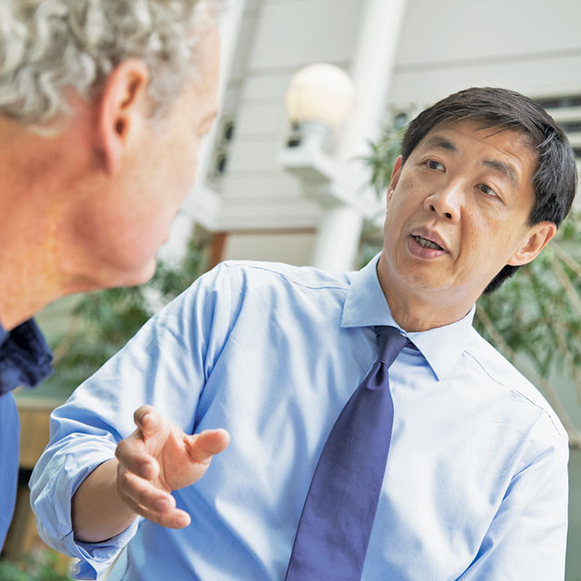 Dr. Harry Quon speaking with a male patient.