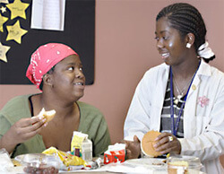 a woman and a nurse talking and eating