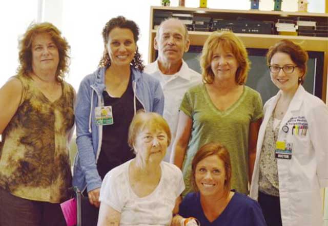 Mary surrounded by her children and the stroke rehabilitation team.