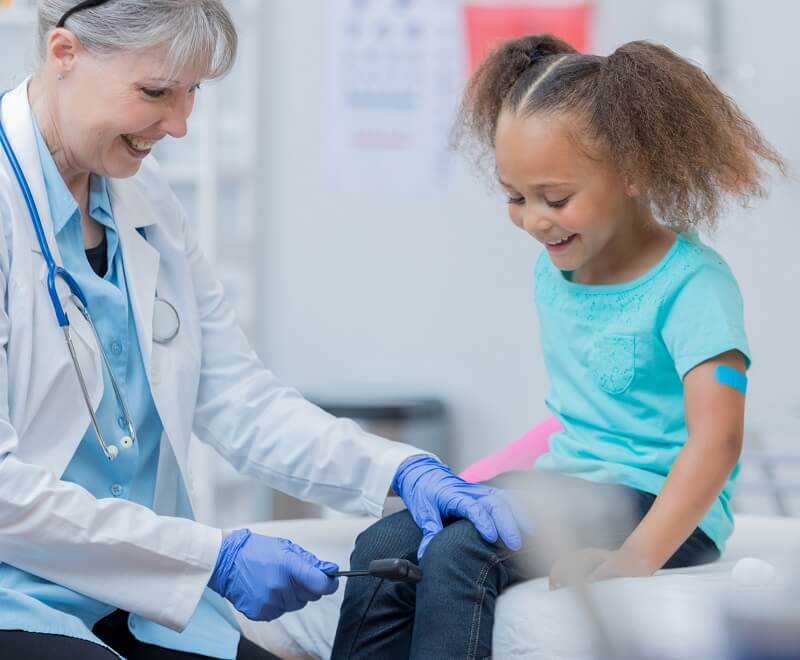 Stock photo of woman doctor with pediatric patient
