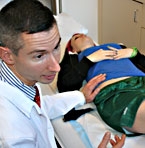 a surgeon examines a patient