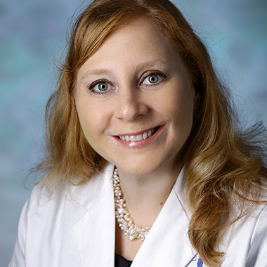 Dr. Irina Burd wearing a white lab coat in a formal portrait.