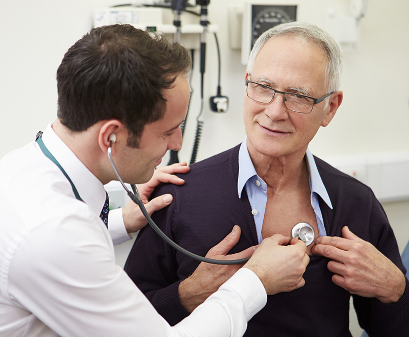 doctor listening to man's chest