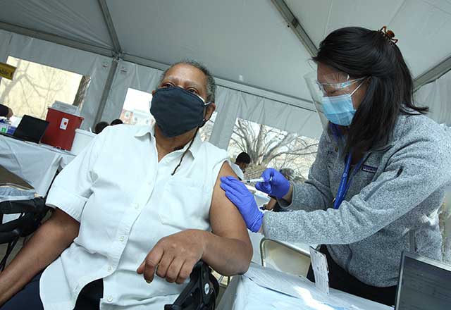 Community member being vaccinated by a healthcare worker.