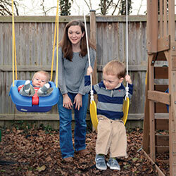 Meredyth Croteau pushing her sons on swings