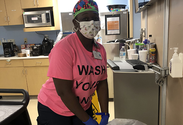 Health care worker wears personal protective equipment while working