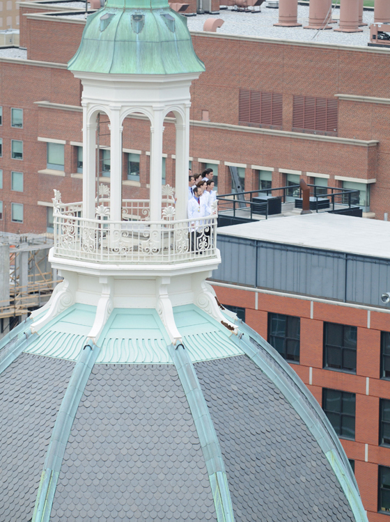 Physicians standing on medical building balcony