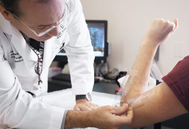 Dr. Ingari measuring elbow range of motion in a UCL tear patient