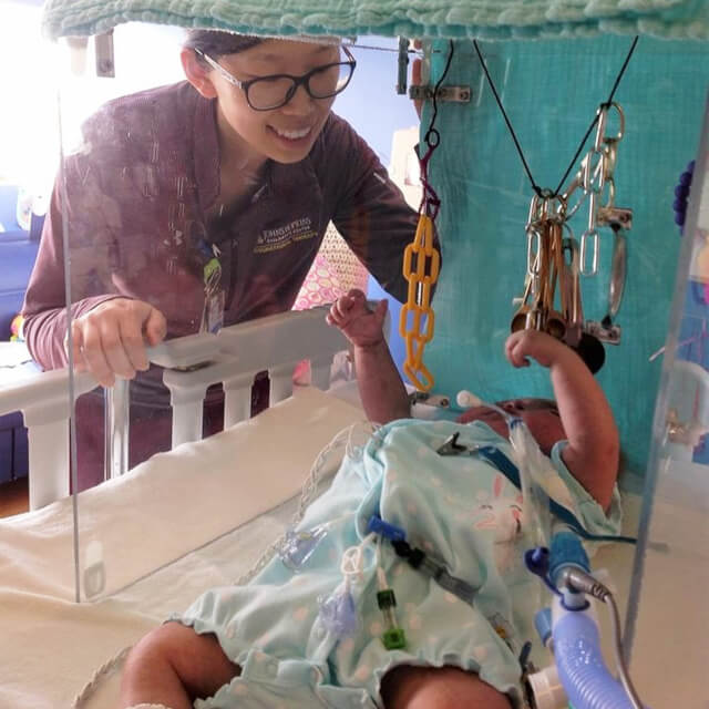 Pediatric physical therapist Yun Kim working with baby Everleigh