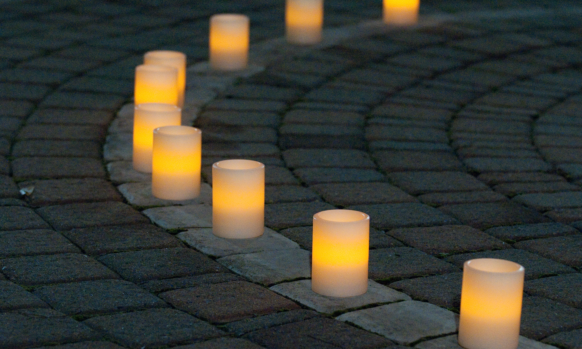 A series of candles lined up on a curve.