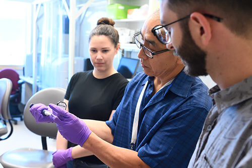 Graduate students work with faculty in the lab.