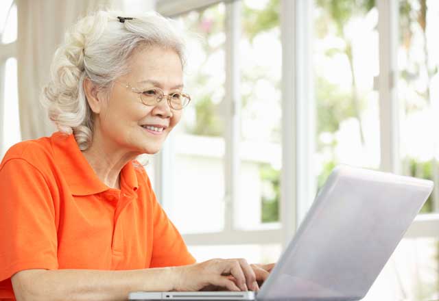 older asian woman using laptop